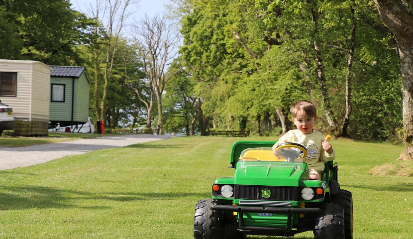 child on a small john deere car